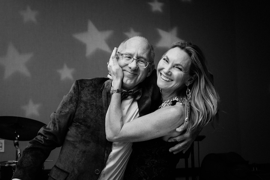 A stunning black and white image of a female hugging her husband at her Birthday Party.